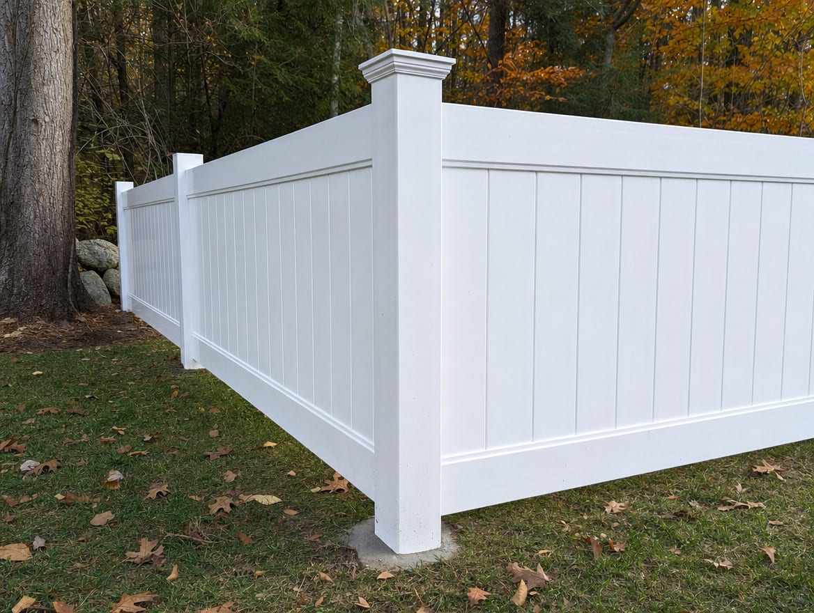 A fence post set in concrete with a clean post cap and precisely aligned rails