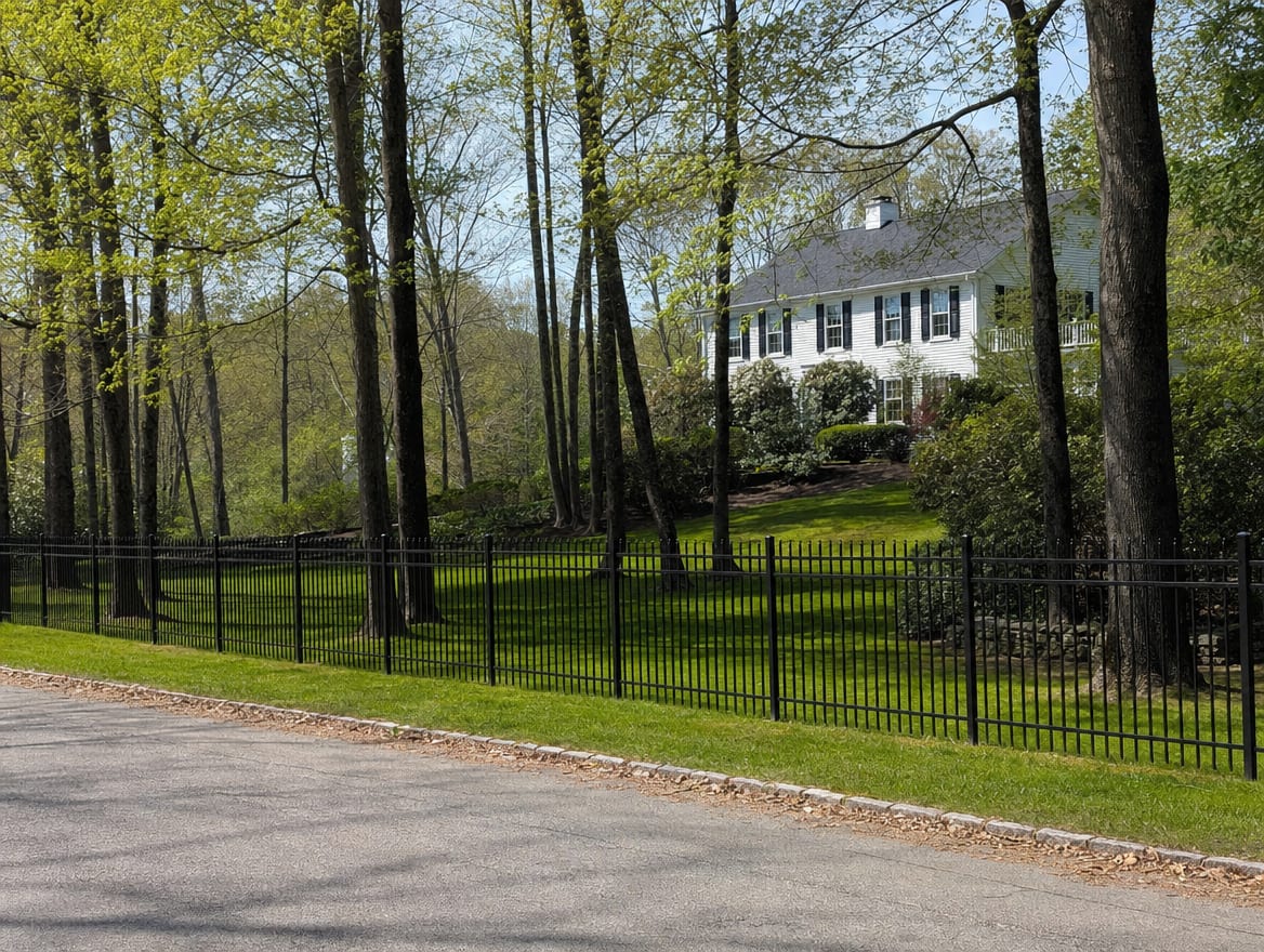 A black aluminum ornamental fence running along a front property line in Washington, CT