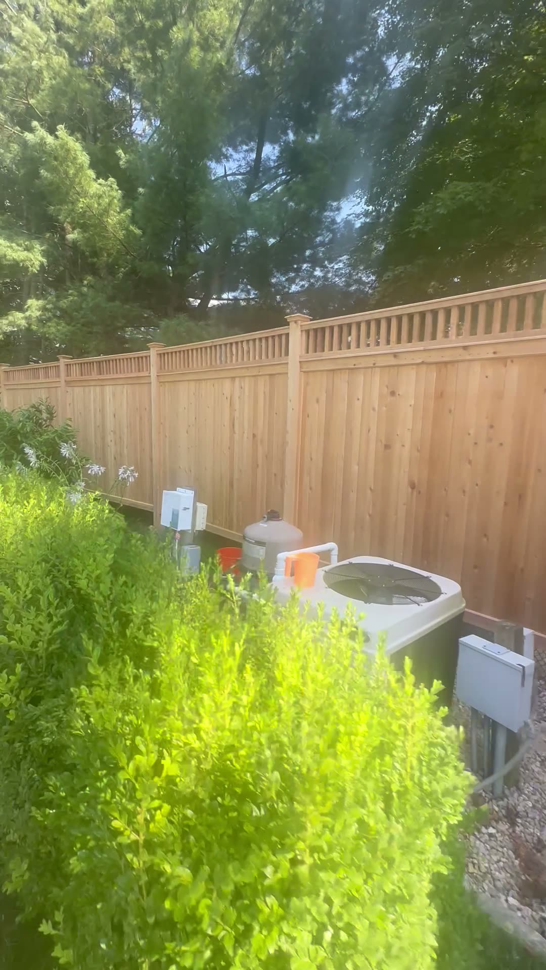 Cedar privacy fence with a decorative spindle top rail
