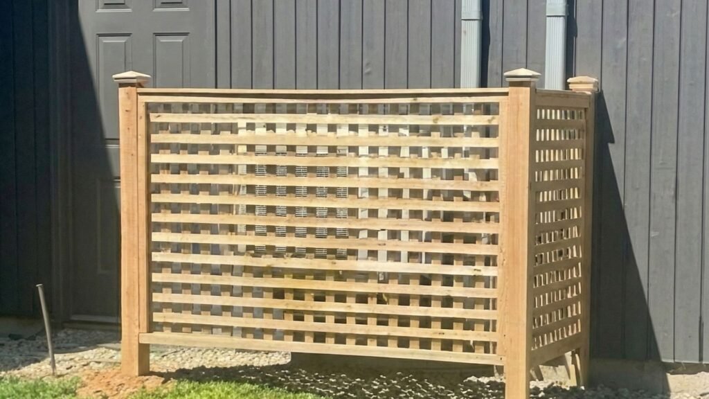 Cedar wood planter enclosure installed against residential building