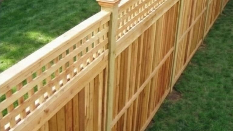 Professional wooden privacy fence with decorative lattice top installed in residential backyard