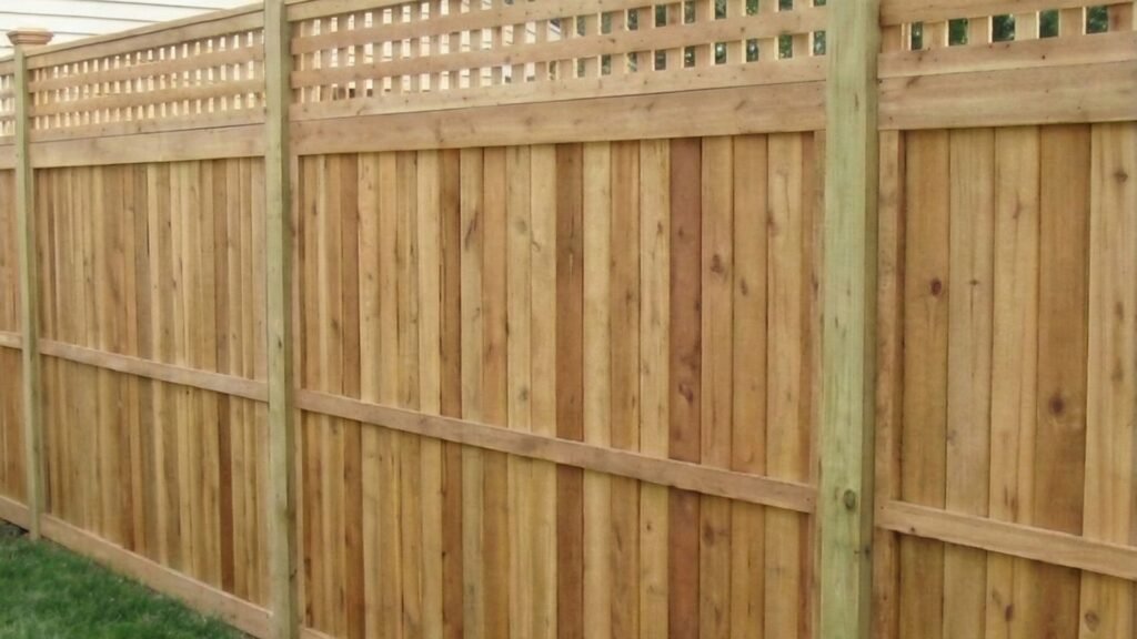 Natural cedar privacy fence with decorative lattice top section installed in residential backyard
