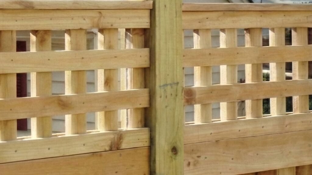 Custom residential wood fence with decorative lattice top panel